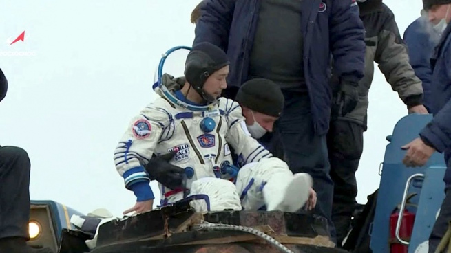 A Japanese billionaire and his assistant return to Earth after 12 days on the ISS