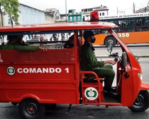 Havana firefighters ride a tricycle