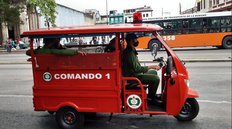 Havana firefighters ride a tricycle