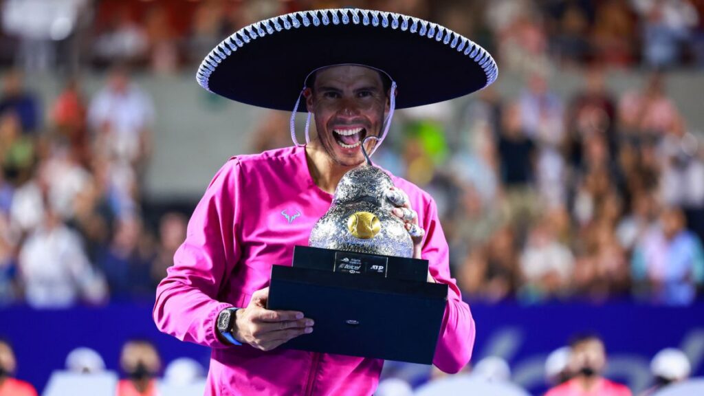 ACAPULCO, MEXICO - FEBRUARY 26: Rafael Nadal of Spain celebrates with the champion trophy after winning the final match between Rafael Nadal of Spain and Cameron Norrie of Great Britain as part of the Telcel ATP Mexican Open 2022 at Arena GNP Seguros on February 26, 2022 in Acapulco, Mexico. (Photo by Hector Vivas/Getty Images)