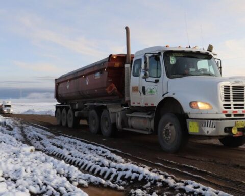 Encapsulated trucks of community members begin transporting mineral in Cusco