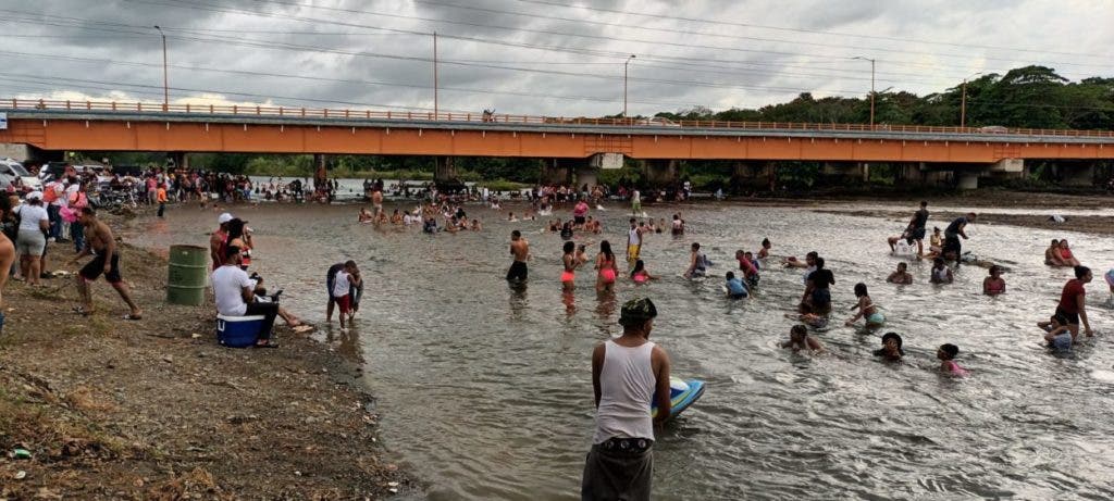 Vacationers enjoy the waters of the Yuna River in Cotuí, after the authorities allow access to it.