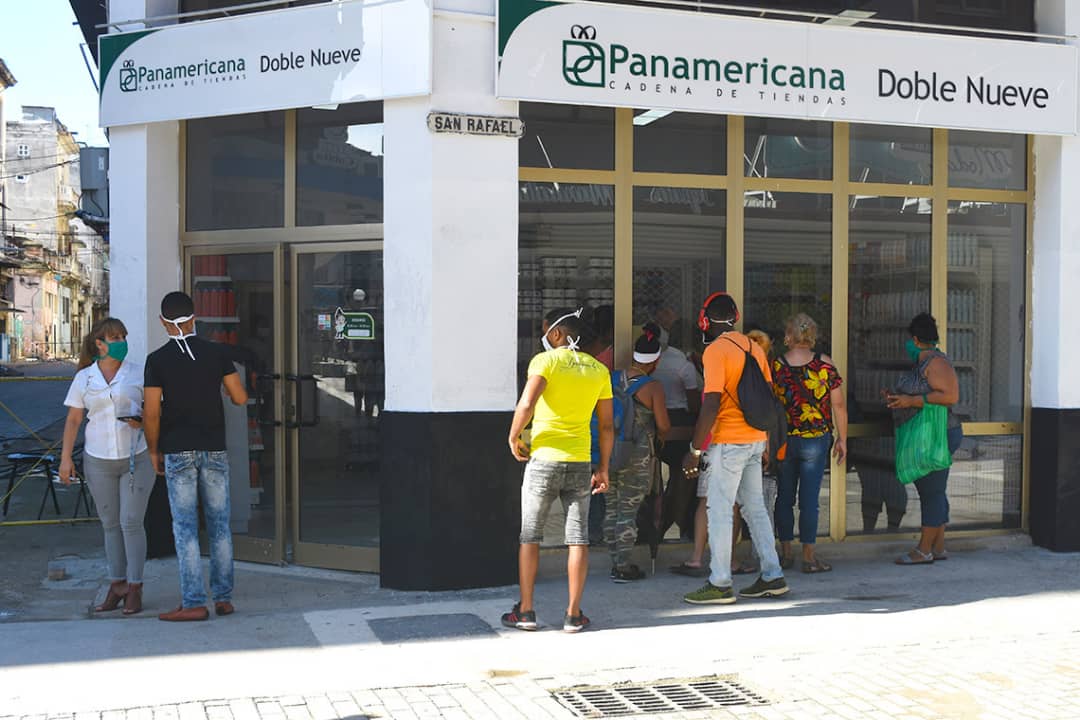 Personas observan a través de las vidrieras de la tienda Doble Nueve, en la calle San Rafael de La Habana, una de las nuevas tiendas que iniciaron la venta de artículos en Moneda Libremente (MLC) este lunes 20 de julio de 2020. Foto: Otmaro Rodríguez.