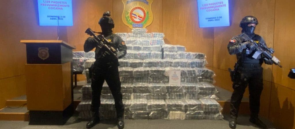 DNCD agents guard the 1,129 packets of cocaine seized at the port of Caucedo on Sunday.