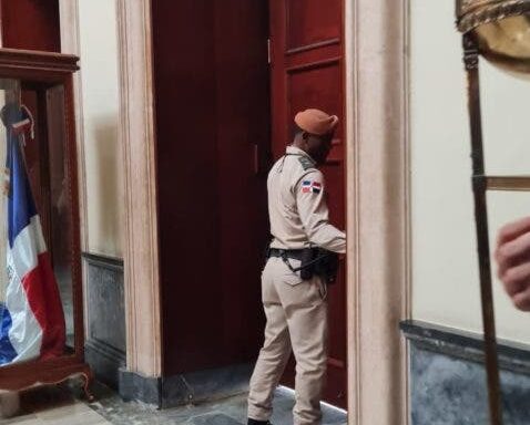 An official of the National Palace closes the entrance doors when the President of the UN Assembly arrived at the Government House.