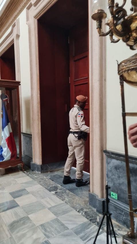 An official of the National Palace closes the entrance doors when the President of the UN Assembly arrived at the Government House.