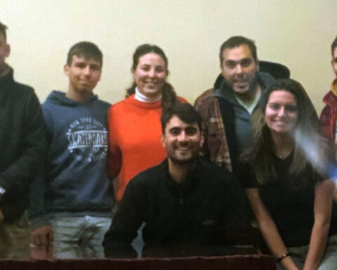 Batllista youth hand in hand with their peers on a tour of the department