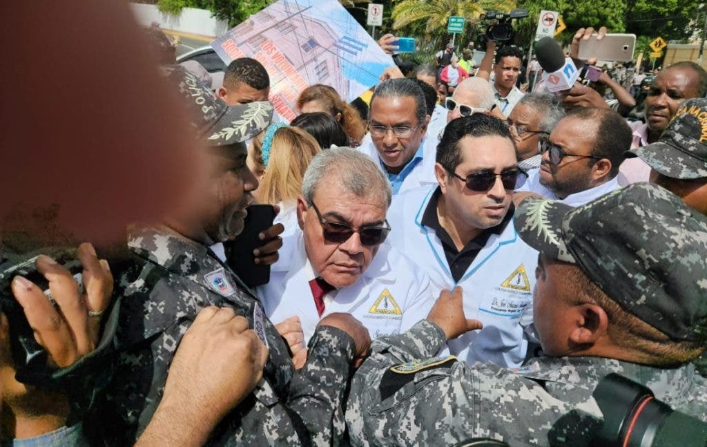 Senén Caba, president of the Medical Association, struggles with police officers during the march.