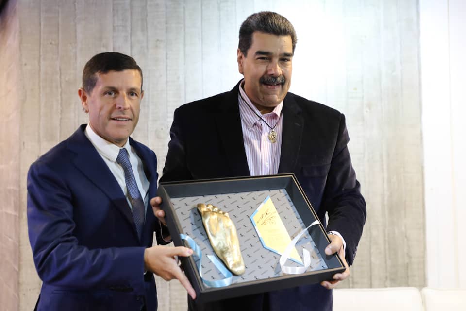 Nicolás Maduro receives a replica of Diego Maradona's left foot