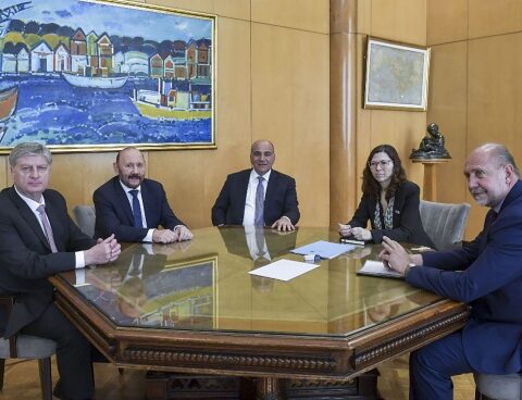 The PC buckles up behind Batakis and raises Evita's flags.