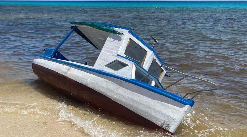 A fisherman points to Cancun as the route used by Cuban coyotes and rafters