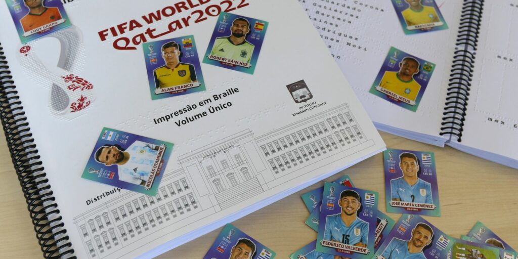 Visually impaired people receive World Cup album in braille