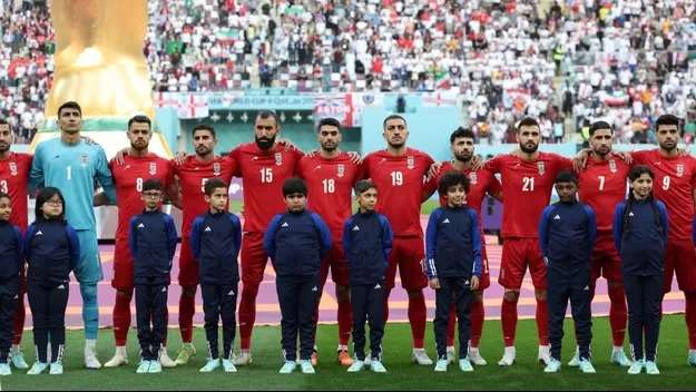 The eleven Iranian starters for the match against England refrain from singing their anthem