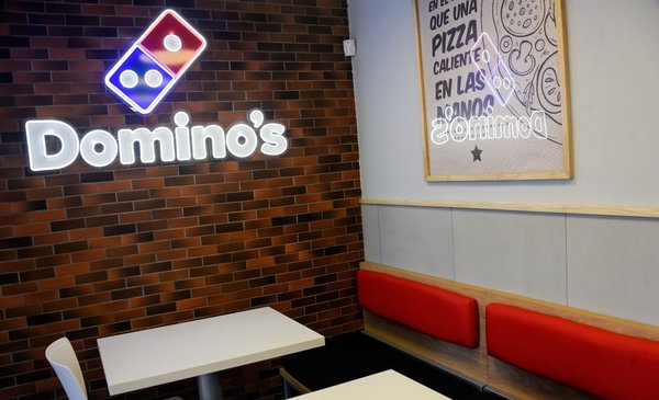 What is the first Domino's Pizza location in Uruguay like and how much do their pizzas cost?