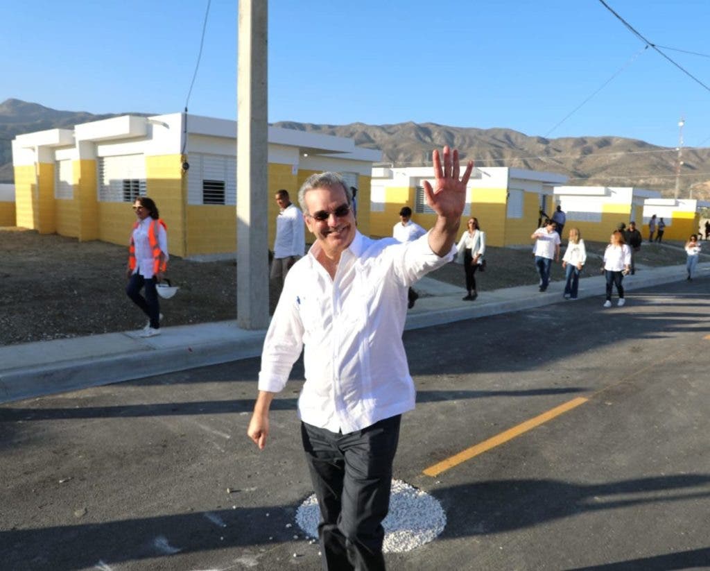 President Luis Abinader greets while walking through one of the streets of the new town to benefit families displaced from the Monte Grande Dam