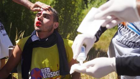 Lewis pawns beat and hold protesters at the entrance to Lago Escondido