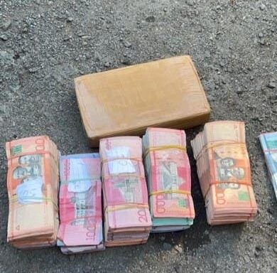 Money and cocaine seized by DNCD in two vehicles.