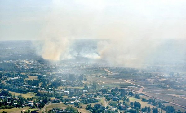 Firefighters fight a fire in a private neighborhood of La Tahona