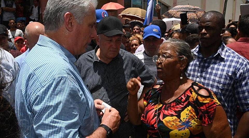 A woman questions the Cuban president during his helicopter tour of the flooded provinces