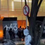 Hooded men destroy establishments during the march through Ayotzinapa