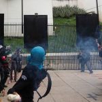 Protesters throw firecrackers at the Senate in protest against the 43