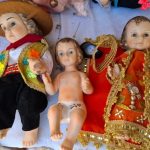 Artisans dress the Baby Jesus in a wanka suit for the Three Kings Day celebration