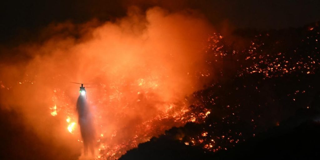 Strong winds reignite fires in Los Angeles