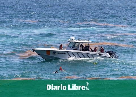 Firefighters deliver the body of a man who fell into the sea