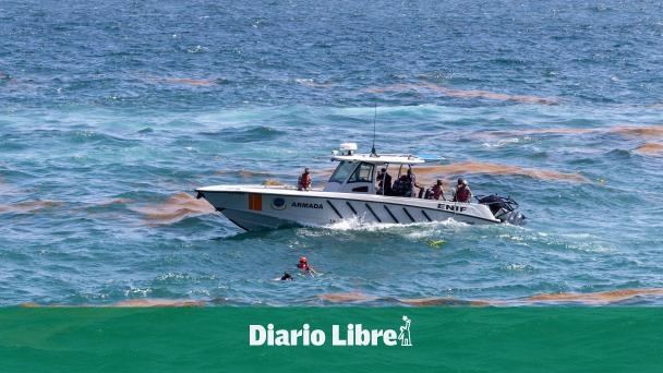 Firefighters deliver the body of a man who fell into the sea