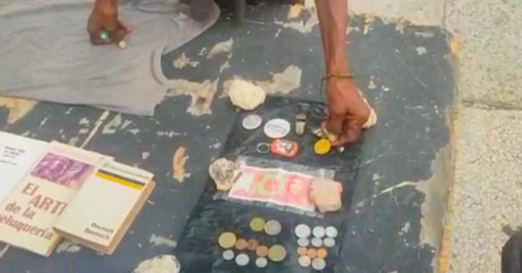 In front of Coppelia, a homeless sells official medals collected in the garbage