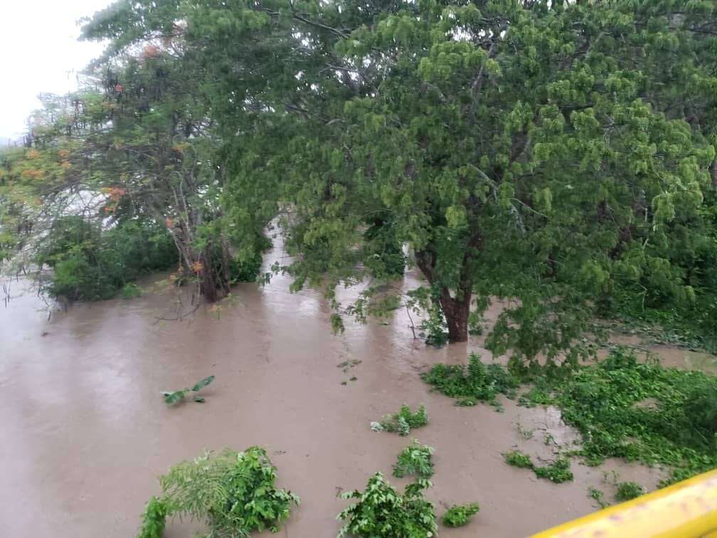 Authorities and residents of Sagua de Tánamo search for two men missing after a river flood