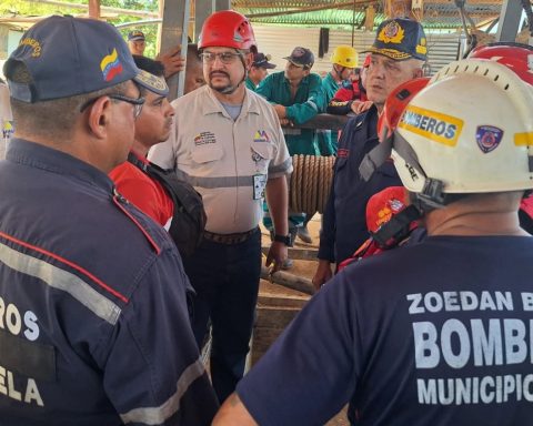 Firefighters rescue the bodies of 14 miners who died due to flooding in the El Callao mine