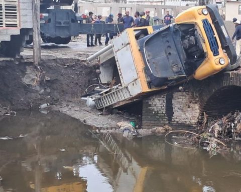 A truck falls off a bridge with its load of two electrical transformers