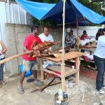 Citizens in Puerto Plata purchase roast pork and other items for the traditional Christmas Eve dinner