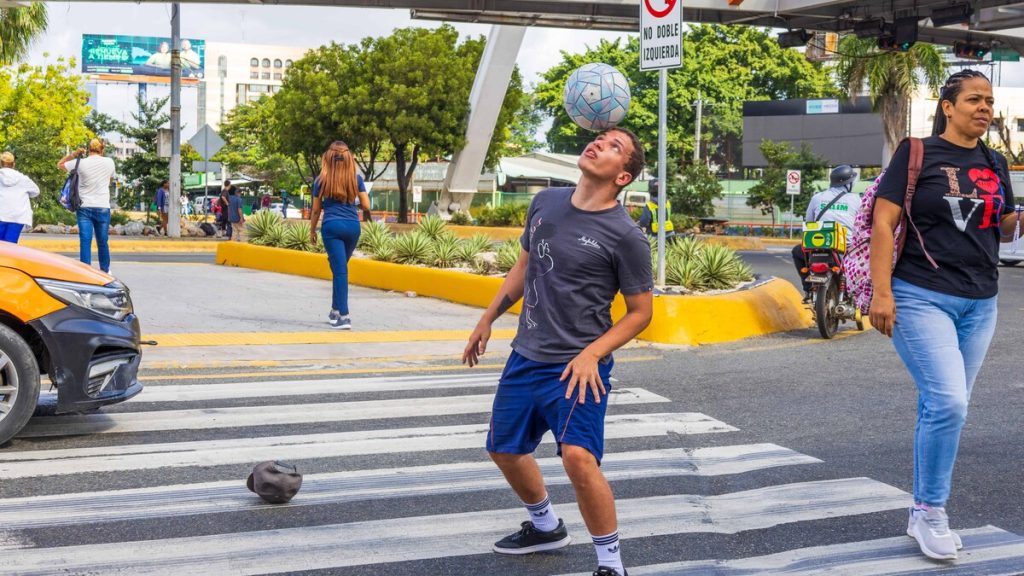 To the rhythm of the lights, a young man performs free soccer acrobatics