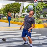 To the rhythm of the lights, a young man performs free soccer acrobatics